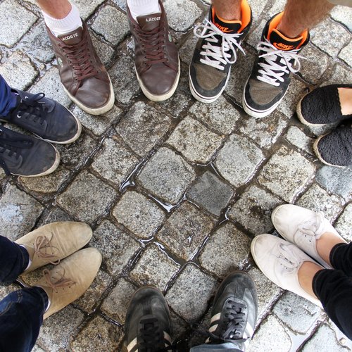 Füße von Jugendlichen, die im Kreis stehen